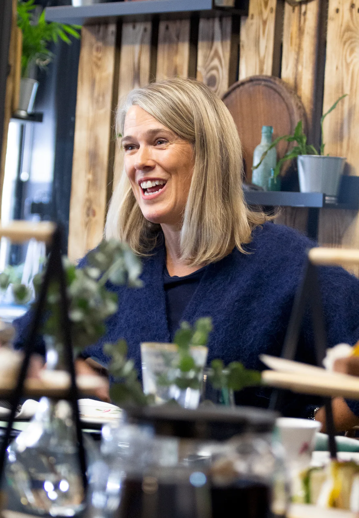 A Strategic Circle member laughing during a relaxed boardroom lunch