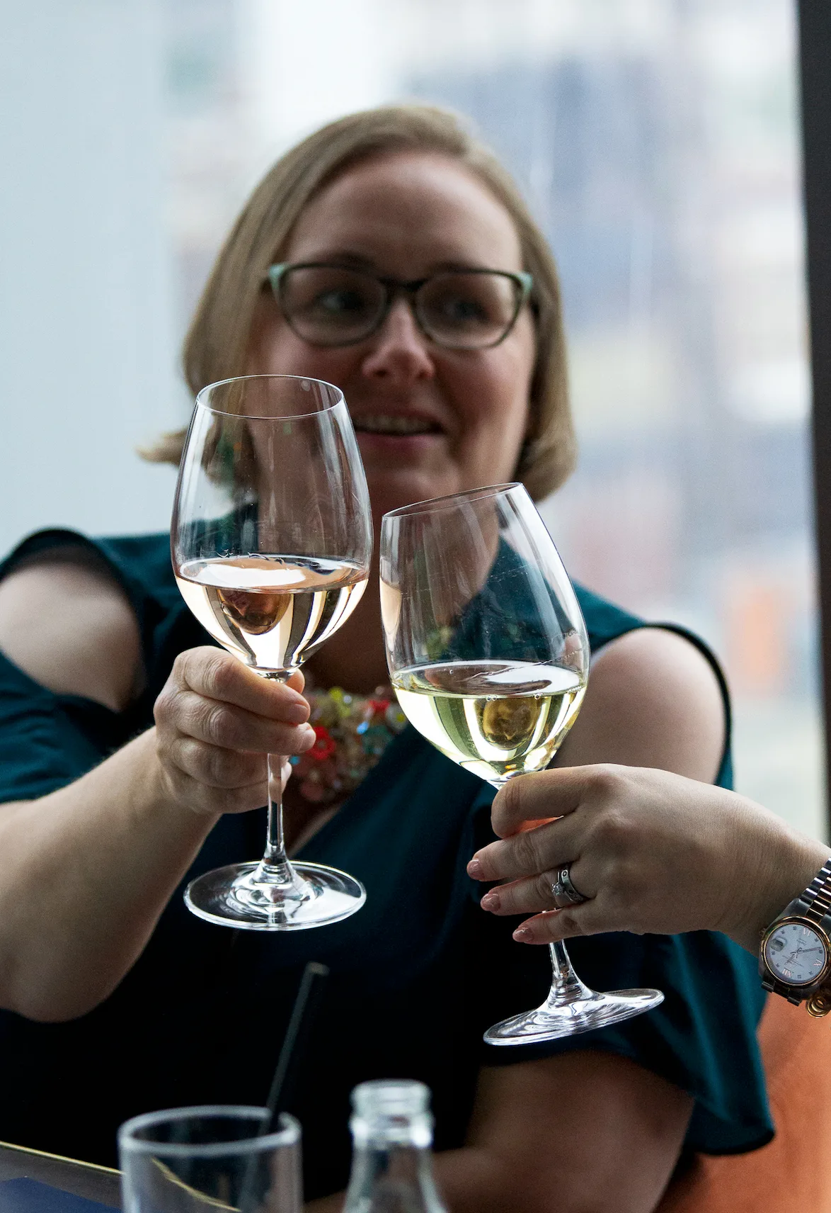Two members toasting with glasses of wine at a Strategic Circle social