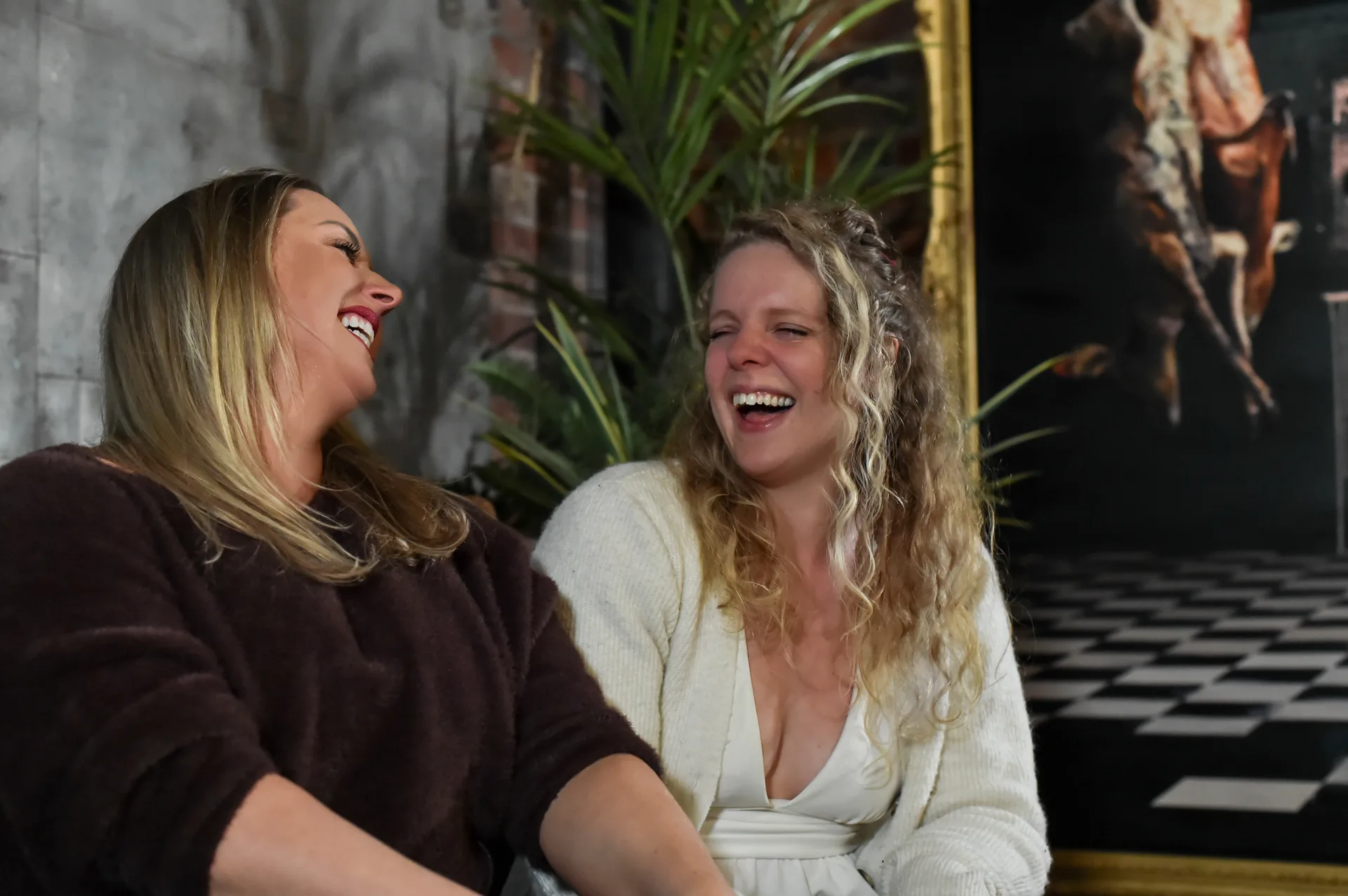 Two Strategic Circle members laughing together at a luxury venue