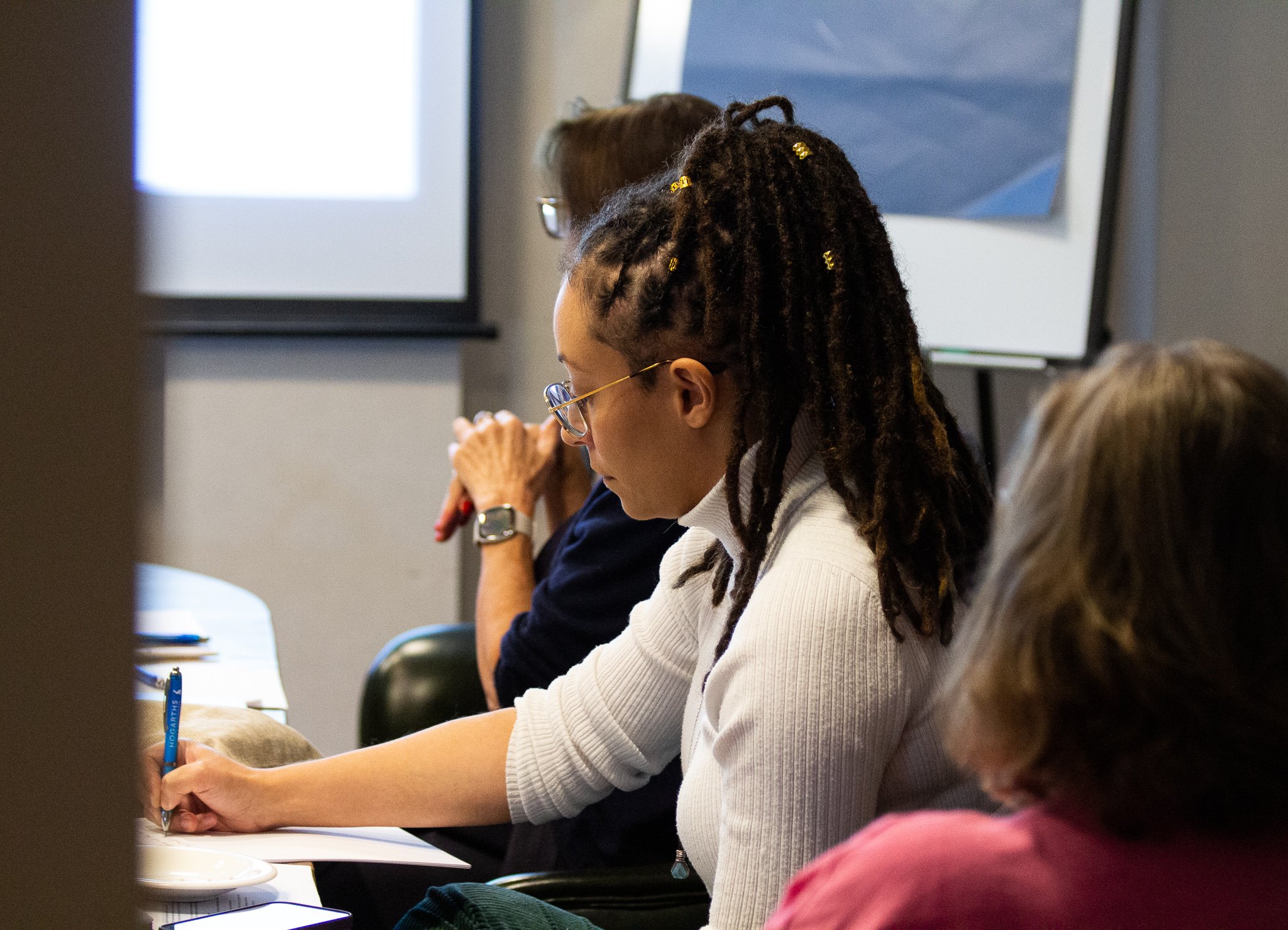 Member taking notes during session